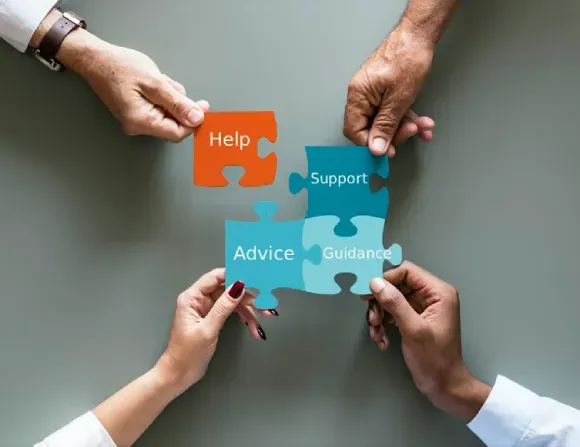Hands collaborating on a puzzle showing Help, Support, Advice, and Guidance — complete support at every step